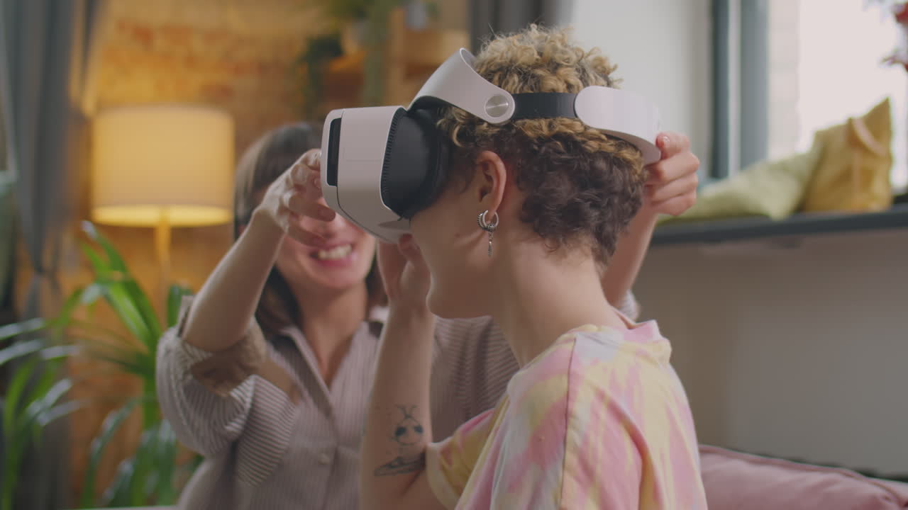 Joyous Girlfriends Using VR Headset at Home