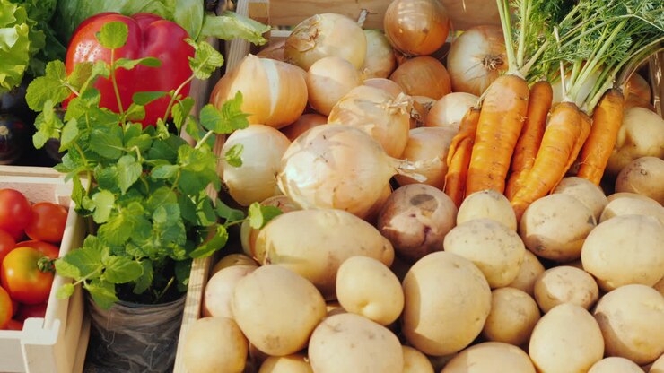 Counter With Fresh Vegetables And A Sign Of Local Products