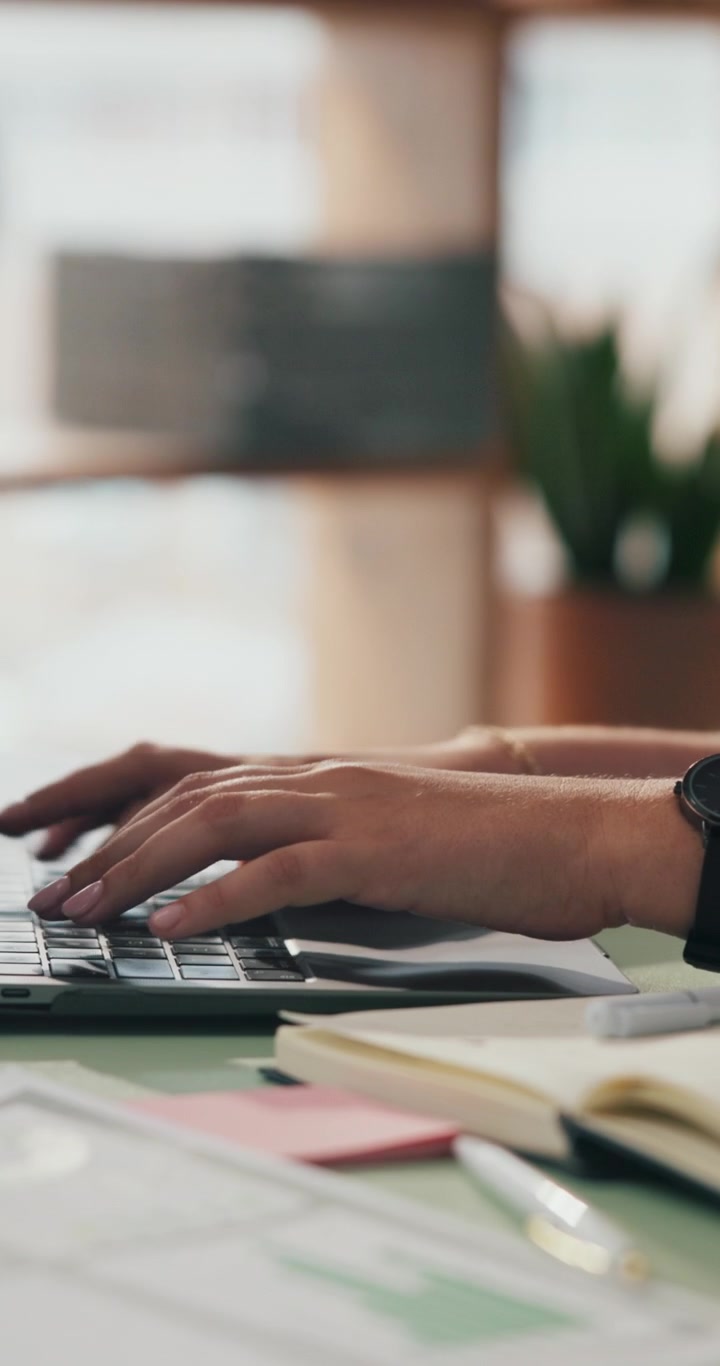 Close-up of Person Typing on Laptop in Office