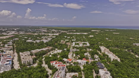 tulum mexico aerial v12 drone flyover luxury residential neighborhood capturing new construction properties surrounded by lush forest and ocean landscape views - shot with mavic 3 pro cine - july 2023