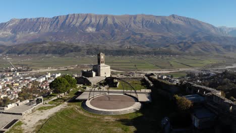 panoramic view from castle of gjirokastra with stone tower over city and mountain background