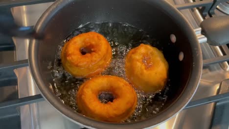 frying home made donuts in vegetable oil