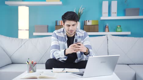 Happy-and-cheerful-young-man-texting-on-the-phone.