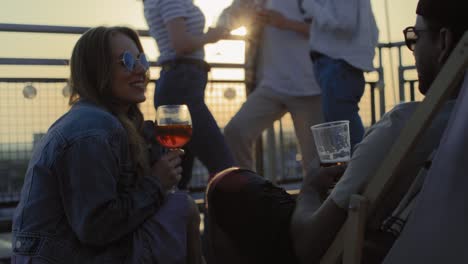 young couple chilling together at the rooftop party.