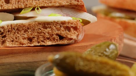 open-faced fish sandwich with pickles and mayo