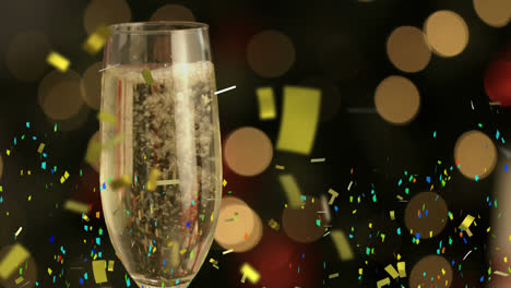 Animation-of-multi-coloured-confetti-falling-against-champagne-flute