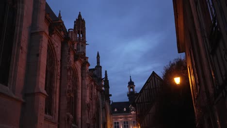 blue hour gothic cathedral religious structures and moody red light, tall buttresses