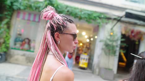 people with pink braids in urban setting