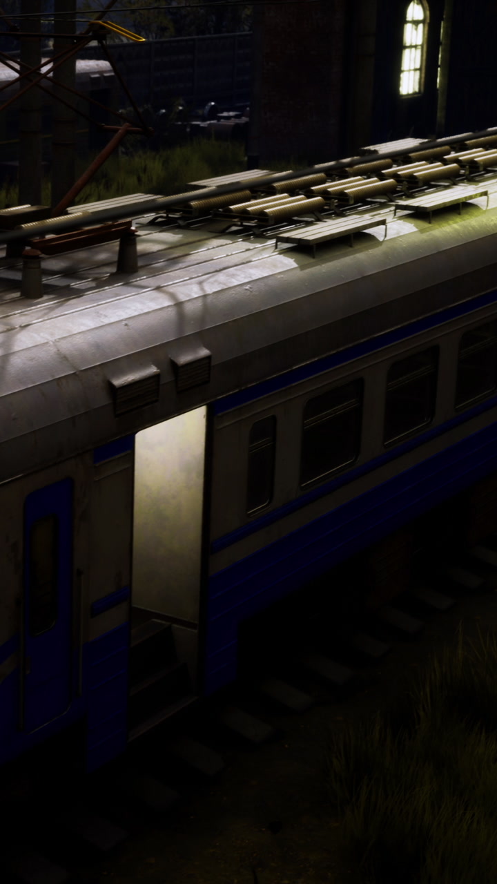 Train car with empty roof rack in a dimly lit setting near a railway