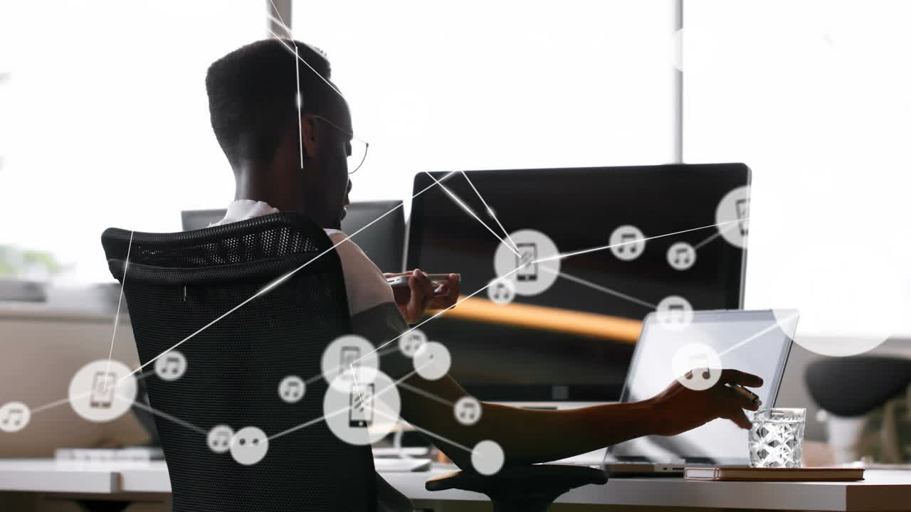 Animation of network of connections with icons over businessman using smartphone