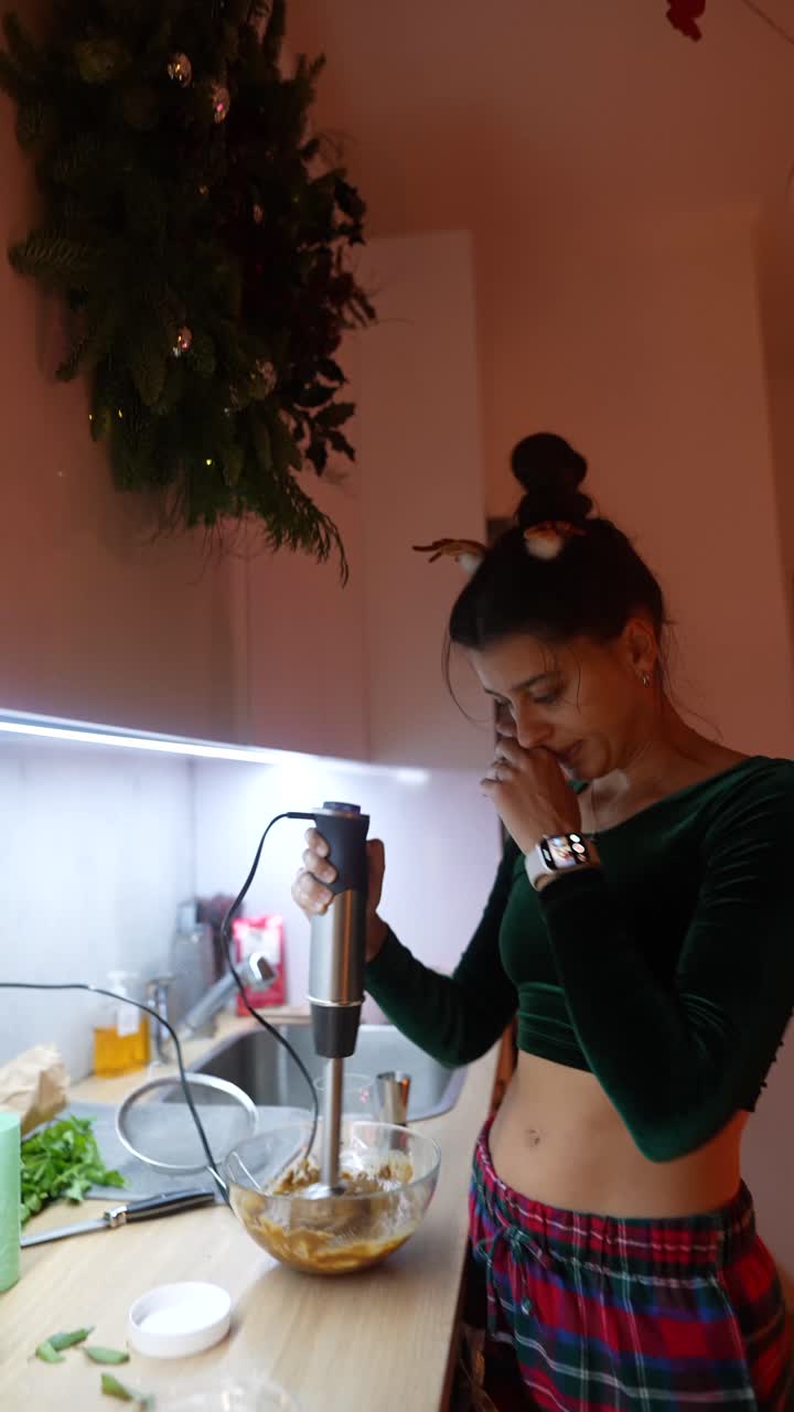 Woman using a blender in the kitchen