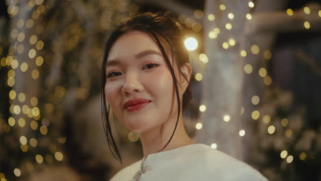smiling asian woman in a white dress