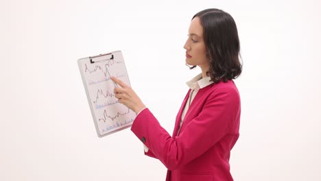 businesswoman analyzing financial charts on clipboard