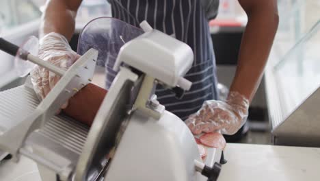 Animation-of-hands-of-biracial-waiter-using-meat-cutting-machine