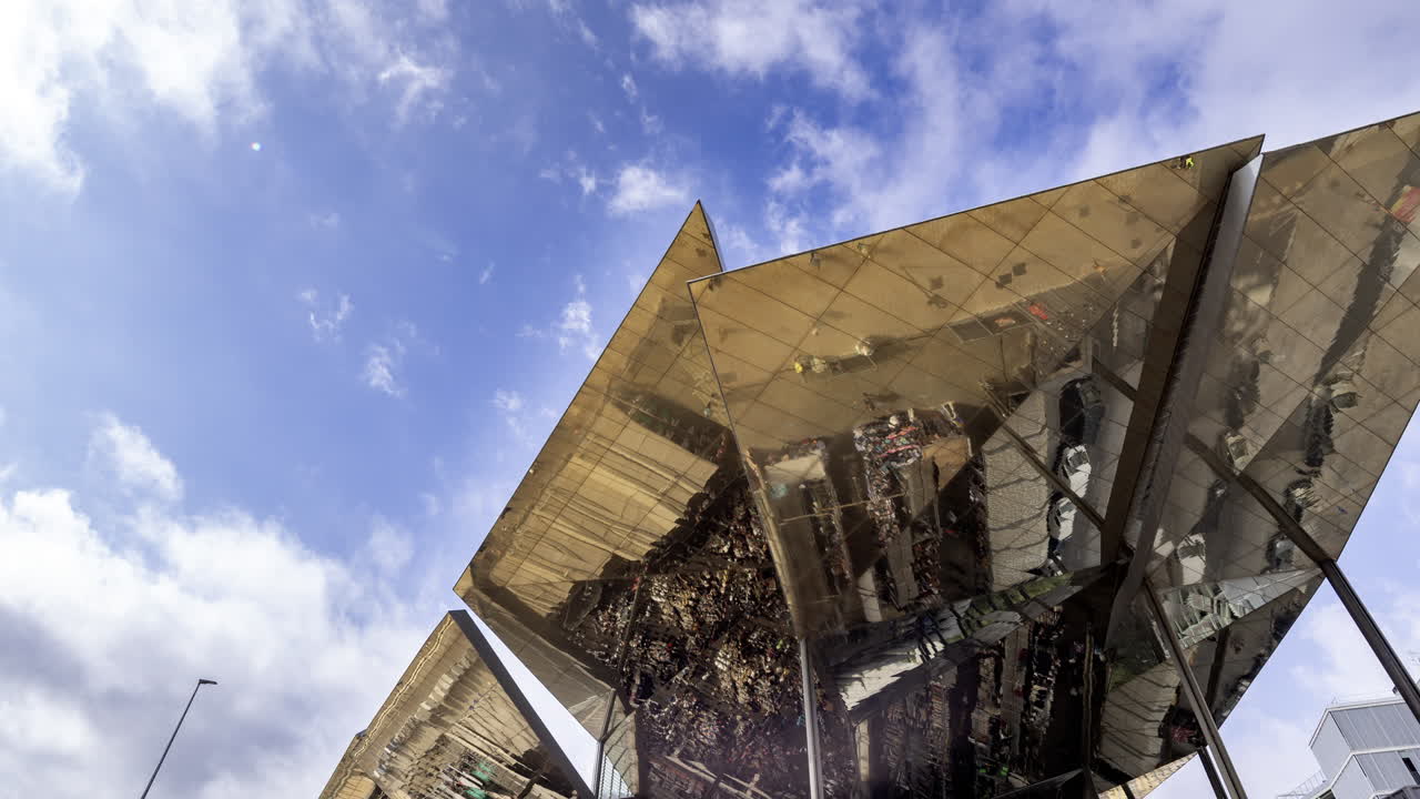 Timelapse of the encants second hand market with gloden reflecting roof in barcelona