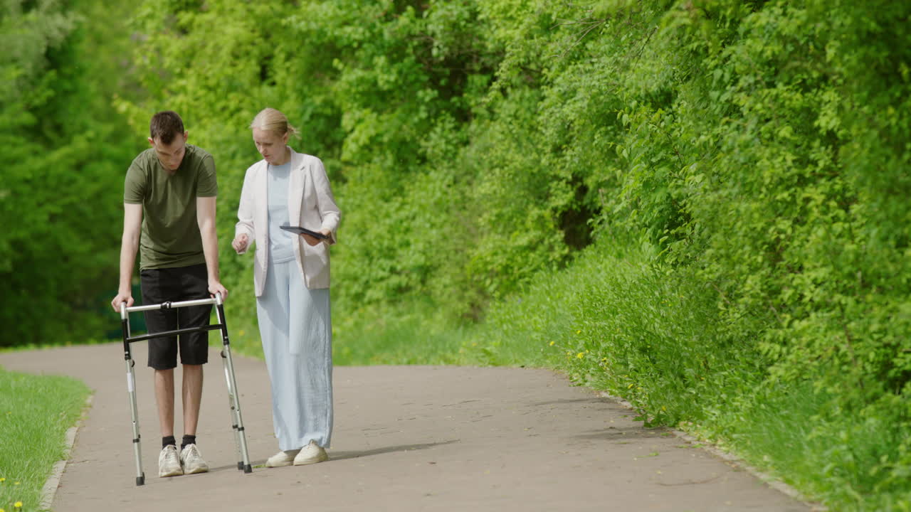 Man with a Walker being Assisted by a Woman in a Park