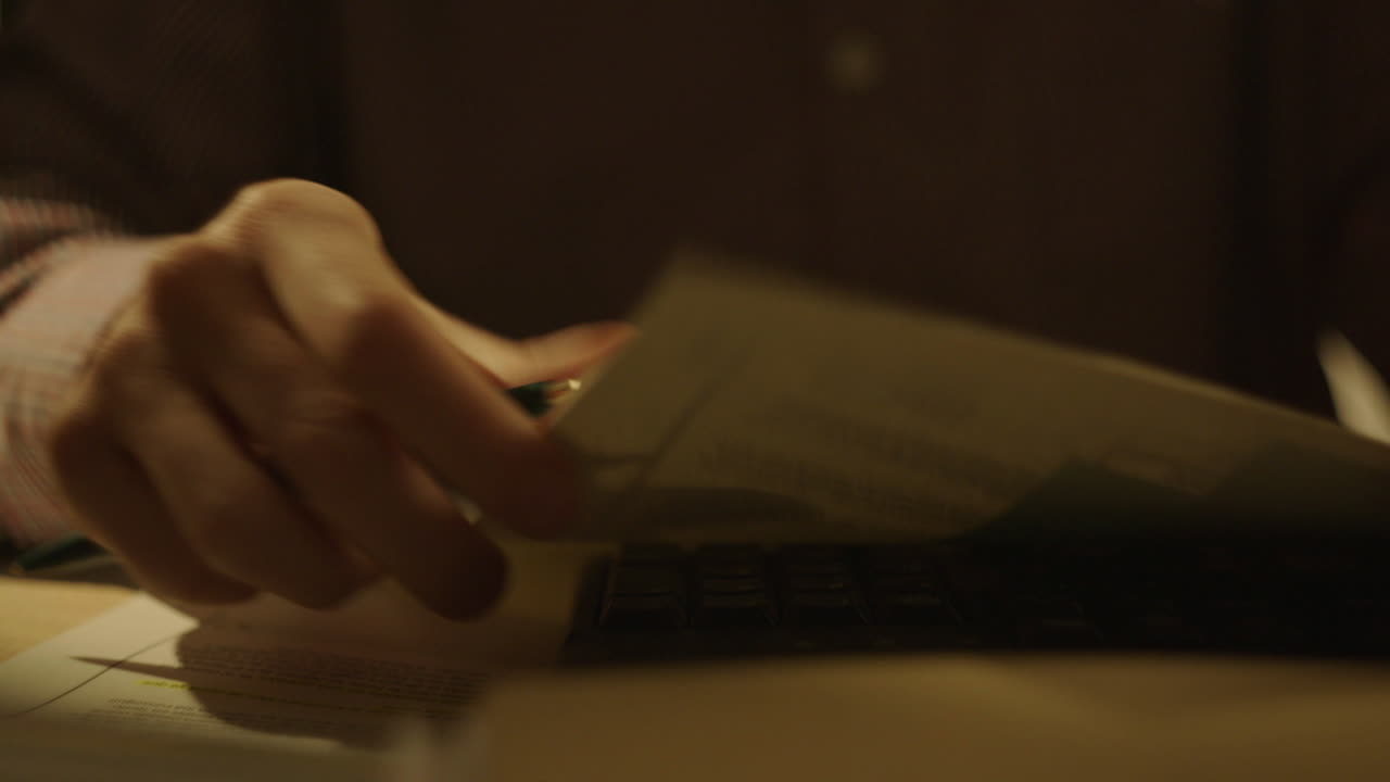 Person Reading Documents at Night