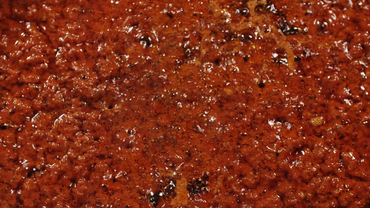Cooking tomato sauce top view. Classic homemade Italian tomato sauce for pasta and pizza in the pan. Chef cooking traditional Italian food. High quality 4k footage