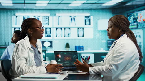 black general practitioner explaining clinical records and results to a patient