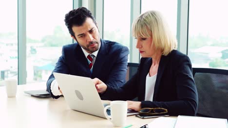 two business people talk project strategy at office