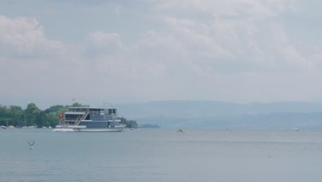 ferry boat sailing on lake zurich blue waters in summer