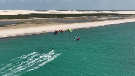 group of kiteboarders having fun together - downwinder along coastline