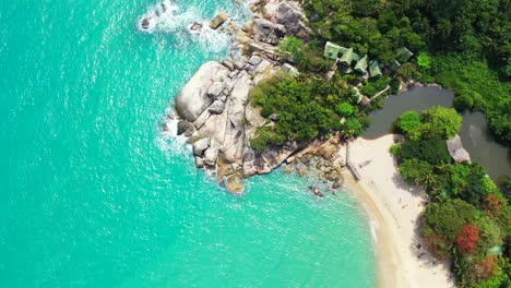 Peaceful-bay-with-turquoise-sea-washing-calm-exotic-beach-and-limestone-big-cliffs-on-coast-of-tropical-island,-Thailand