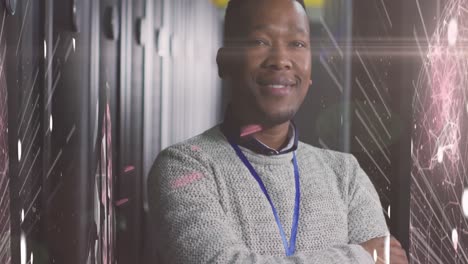 Animation-of-globe-and-lights-over-african-american-man-posing-in-server-room