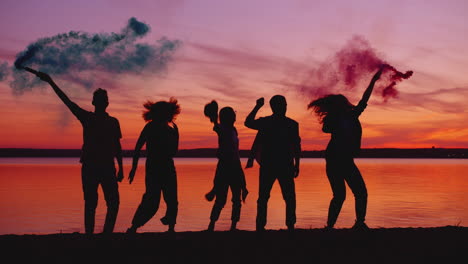friends celebrating sunset by the lake