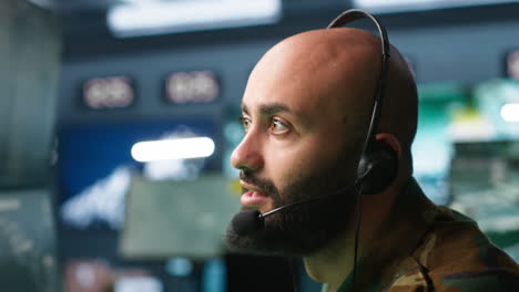 Radio-communications-operator-discussing-with-colleague-using-headset-mic