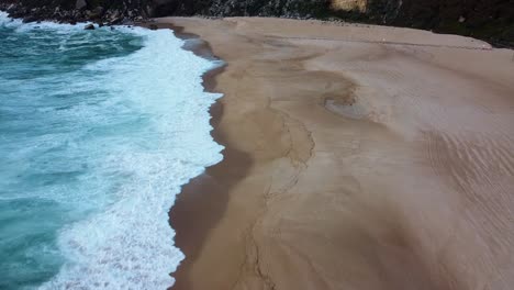 Aerial-View-Of-Nazare-Beach-Waves-On-Atlantic-Ocean-Coast-In-Portugal