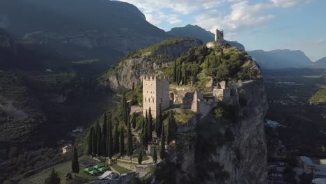 old european fort castle remains on top of a mountain cliff side, castello di arco, riva del garda