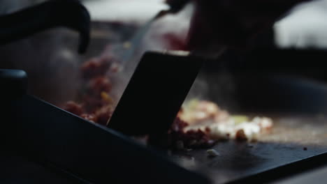 Throwing-sliced-paprika-into-wok-dish,-then-flipping-it-with-spatulas