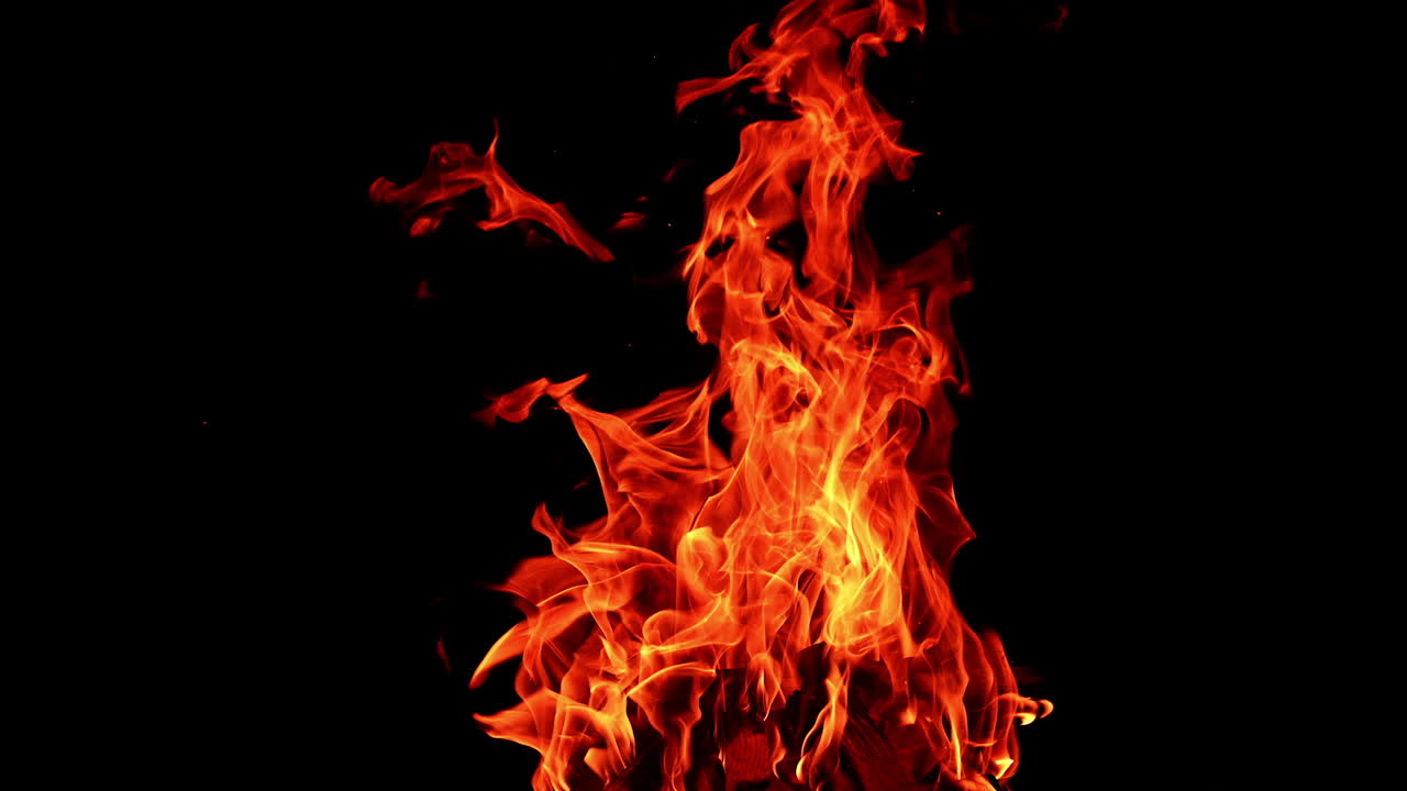 Fire flame on isolated black background. Fire sparks glowing with warm.