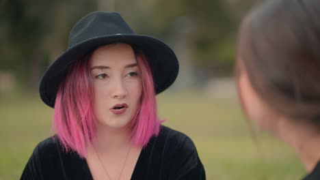 two women in conversation in a park