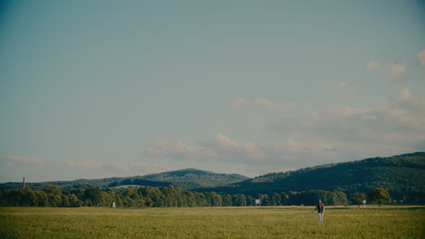 carefree woman strolling on grass in meadow