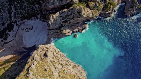 top view of sa calobra beach and torrent de pareis between sheer rock cliffs in mallorca, spain