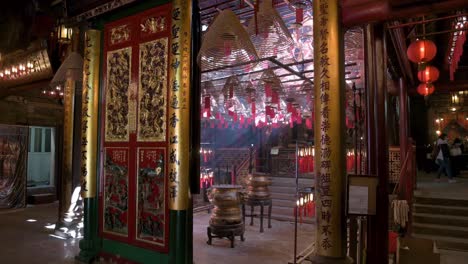 incense coils hanging from the ceiling as they burn inside a taoist temple to attract the attention of the gods in hong kong