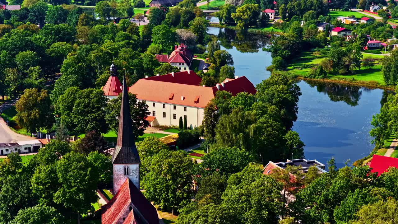 Peaceful aerial view of historic Jaunpils in Latvia, lush landscape