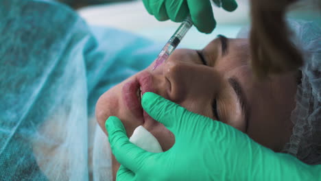 mature woman undergoes painful lips augmentation procedure