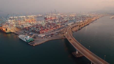 Aerial-Shot-Of-Algeciras-Shipping-Port-Near-Suspended-Long-Bridge,-Spain