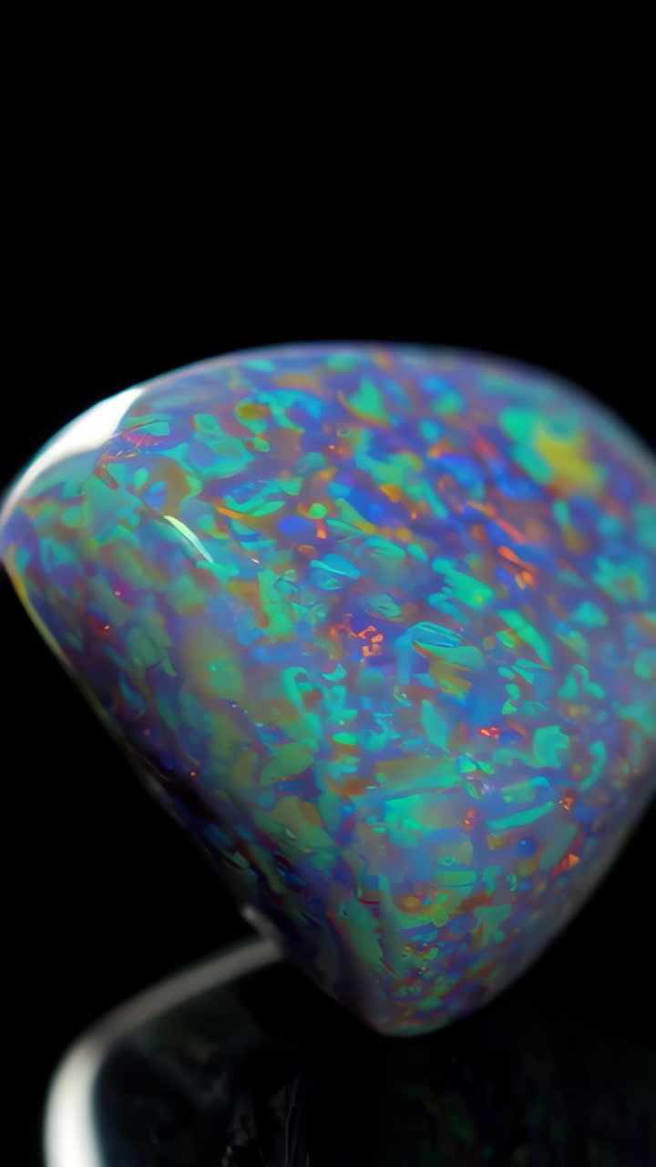 Vibrant Opal Gemstone with Play of Color on a Black Background