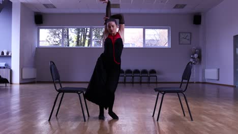 professional female dancer dances around two chairs