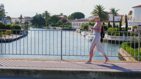 Junge-Touristische-Frau-Zu-Fuß-Auf-Der-Brücke-über-Den-Kanal-Der-Gegend-Empuriabrava-Spanien-Steadicam