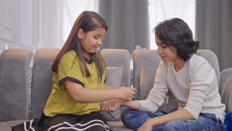 indian kids celebrating raksha bandhan festival by trying rakhi