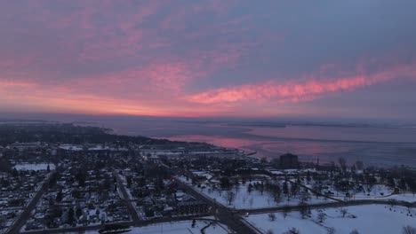 Aerial-timelapse-of-a-red-sky-sunrise-over-a-city-waterfront