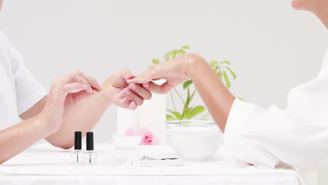 woman getting a manicure at nail salon