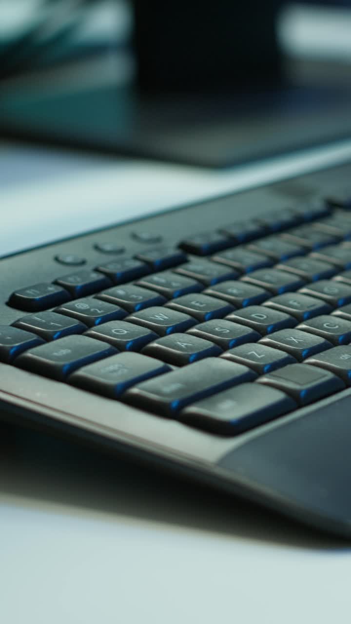 Programming Code on Computer Screen and Keyboard on Desk