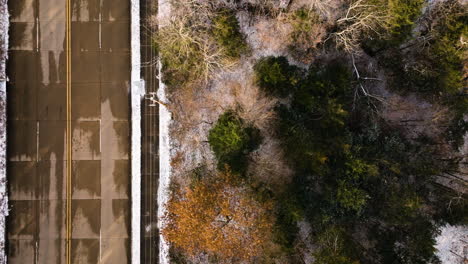 Overhead-view-of-Mount-Sequoyah,-AR,-USA-with-trees-and-a-road-in-winter-light,-aerial-shot