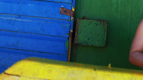 Girl-photographing-with-camera-from-colorful-beach-hut